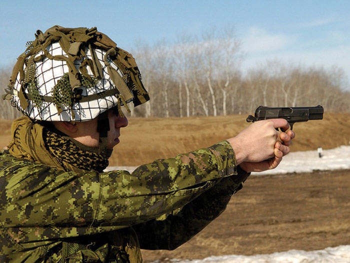 Canadian soldier with Hi-Power pistol